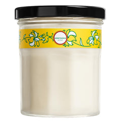 Mrs. Meyer's Honeysuckle candle jar glows with inviting floral fragrance.