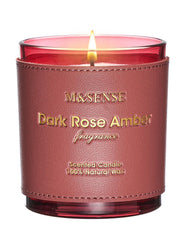 M&SENSE Rose Amber candle in a glass jar emits warm glow for cozy evenings.