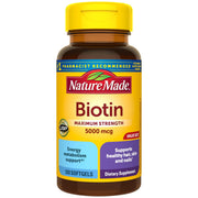 Nature Made Biotin 5000 mcg softgel bottle on counter for daily hair and nail support.