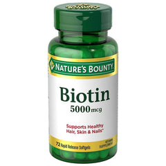 Nature's Bounty Biotin 5000 mcg capsules on bottle, supports healthy hair, skin and nails.