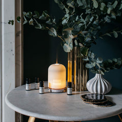 NEOM wellbeing pod diffuser closeup shows a simple calming ritual setup.