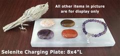 Close-up texture of New Age Imports selenite charging plate showing natural mineral patterns.