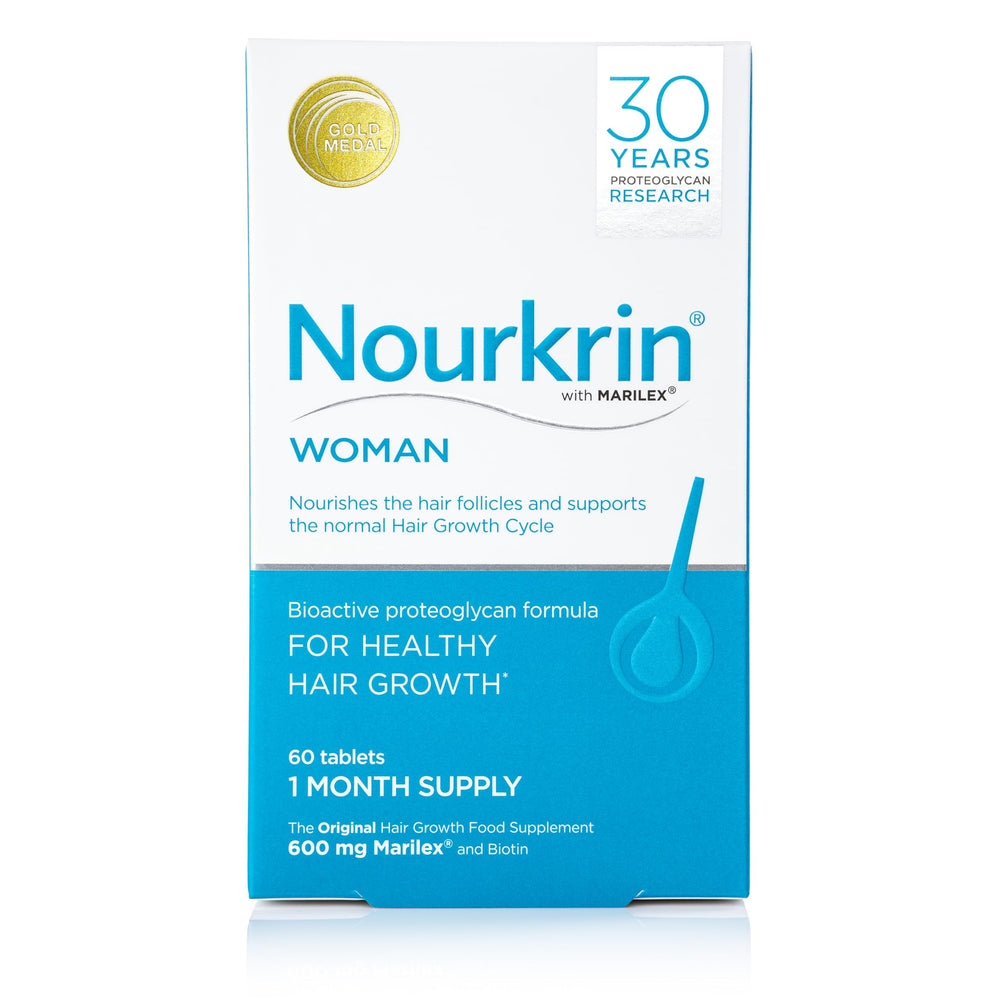Nourkrin Woman tablets pack on a clean counter, highlighting daily hair nourishment.