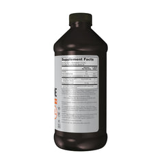 NOW Foods L-Carnitine Liquid citrus flavor poured into a glass for quick mixing.