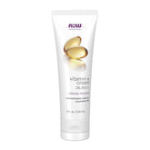 NOW Foods Vitamin E Cream bottle close-up showing 28,000 IU hydration for face and body.