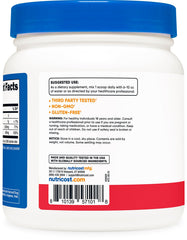 Nutricost Fruit Punch flavored powder dissolving in water in a glass.
