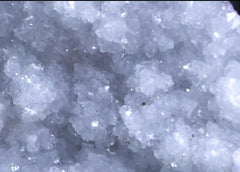 Okenite Druzy Crystal Cluster in a peaceful setup suggests space for spiritual practice.