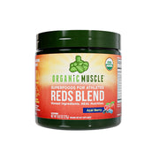 Organic Muscle Reds Powder bottle on a clean counter highlighting caffeine-free energy potential.