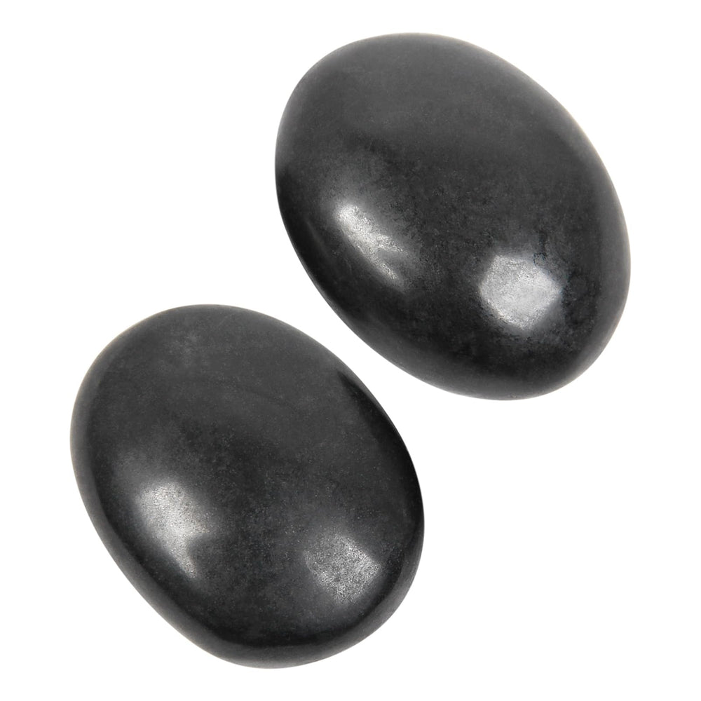 Orientrea black tourmaline palm stone held for grounding and focus.