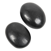 Orientrea black tourmaline palm stone held for grounding and focus.