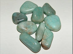 Pachamama Essentials Amazonite tumbled stone in hand for grounding and balance.