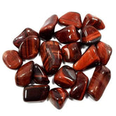 Pachamama Essentials Red Tiger Eye tumbled stones to boost vitality and focus.
