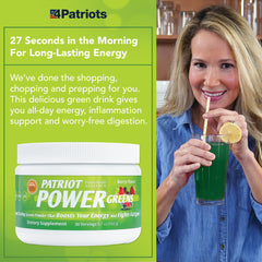 Scoop of Patriot Power Greens powder beside a glass for easy smoothie mixing