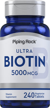Piping Rock Biotin 5000mcg tablets on a clean surface for beauty support.