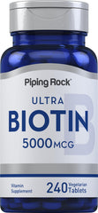 Piping Rock Biotin 5000mcg tablets on a clean surface for beauty support.