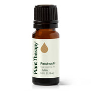 Plant Therapy Patchouli oil bottle in amber glass for aromatherapy sessions.
