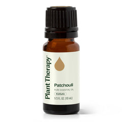 Plant Therapy Patchouli oil bottle in amber glass for aromatherapy sessions.
