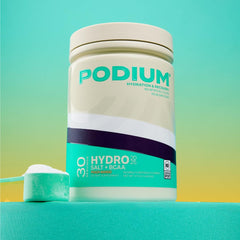 Podium Nutrition Hydro Salt peach mango mixed glass showcasing refreshing hydration.