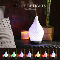 Porseme diffuser with wood grain base and LED lights creates warm, decorative lighting.