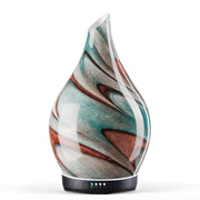 Porseme teal green diffuser with glass body emitting soft glow for a calm room