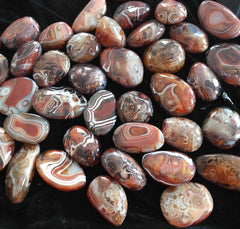 Pounique Banded Lace Agate in hand demonstrating soothing grip for relaxation