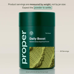 Proper The Greens ready-to-mix scoop beside a glass of apple-flavored drink