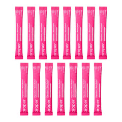 Proper Pinks powder scoop next to a glass, highlighting easy daily intake.