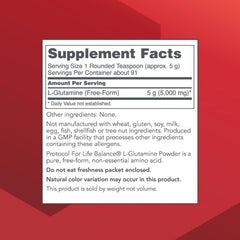 Pouring Protocol For Life Balance L-Glutamine powder from the tub into a glass for mixing.