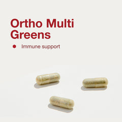 Open bottle of Ortho Multi Greens with capsules ready to take daily.