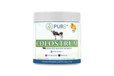 PURE Colostrum Orange powder in a glass jar for daily wellness.