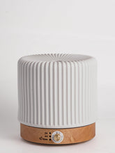 QCYBDGLOV ceramic diffuser on an office desk for subtle aroma.