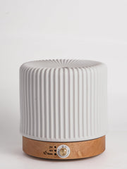 QCYBDGLOV ceramic diffuser on an office desk for subtle aroma.
