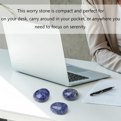 QINJIEJIE blue sodalite stone in hand for tactile energy guidance.