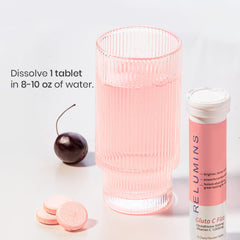 Relumins Gluta C Fizz cherry-flavored tablet in a glass, convenient for hydration and flavor.