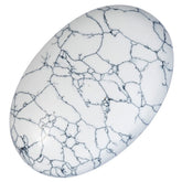 Rockcloud oval worry stone in white howlite turquoise, calm tactile focus.