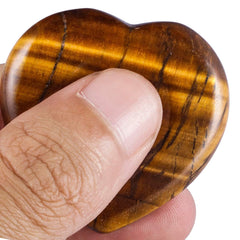 Rockcloud palm stone tiger's eye crystal aids meditation and grounding practice.