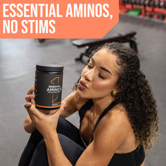 Rule 1 Essential Amino 9 scoop beside a blue drink to mix