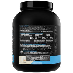 Rule 1 Whey Protein scoop ready to mix with cold beverage.