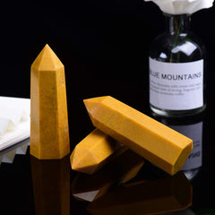 Desk or altar setup featuring a yellow aventurine wand with warm glow.
