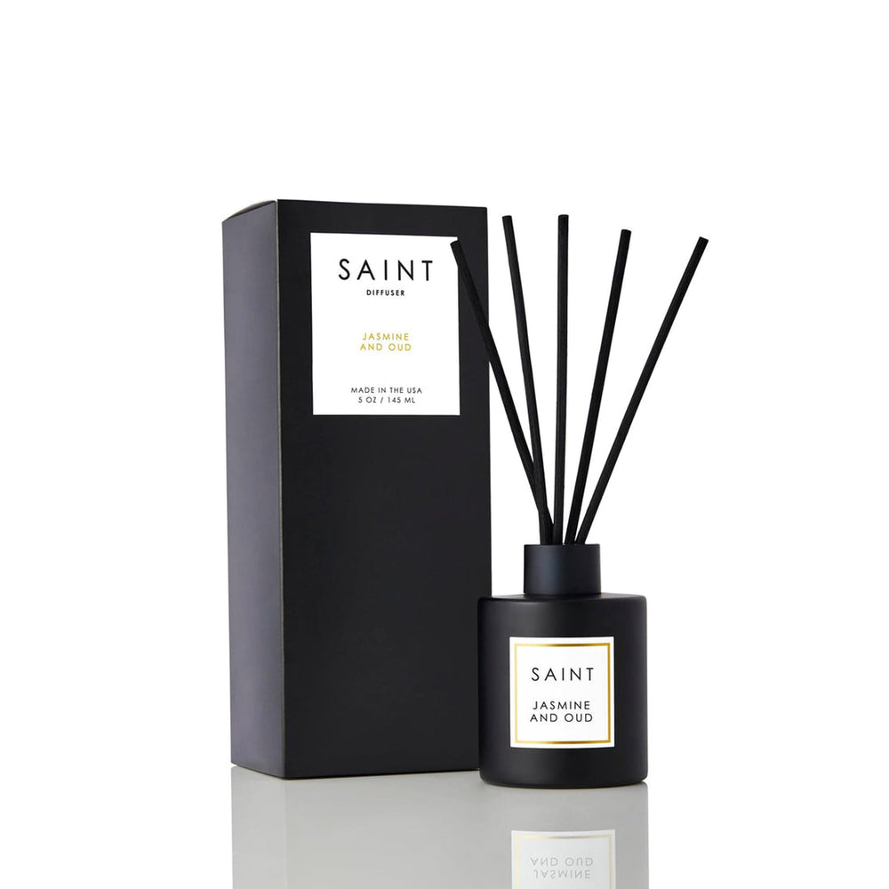 Saint Jasmine Oud reed diffuser in matte black jar releasing a rich aroma for living room ambiance