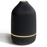 Salubrito compact essential oil diffuser in black on a desk, space-saving design