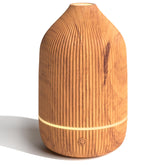 Salubrito essential oil diffuser with wood grain on desk delivers subtle ambient aroma.