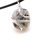 Shelf and Stone Rainbow Moonstone pendant close-up with iridescent glow for new beginnings.
