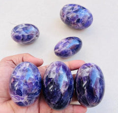 Shiva crystal lingam in purple enhancing spiritual ambiance.