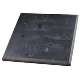 Shungite World polished 100x100mm tile shown as a balanced charging plate on a desk