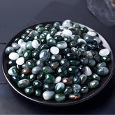 SigMntun moss agate chips close-up, smooth polished surface for jewelry making.