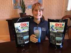 Canister close-up of Skinny Jane GO Pro Shakes showing whey protein formula