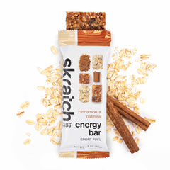 Skratch Labs Energy Bar Cinnamon Oatmeal on trail scene suggests sustained energy during outdoor activities.