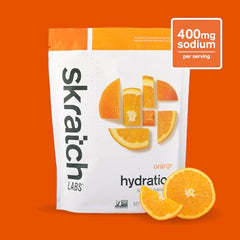 Skratch Labs Hydration Orange mixed glass showing refreshing citrus beverage