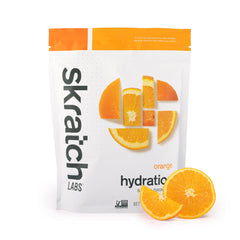 Skratch Labs Hydration Orange powder with scoop for fast rehydration after workouts